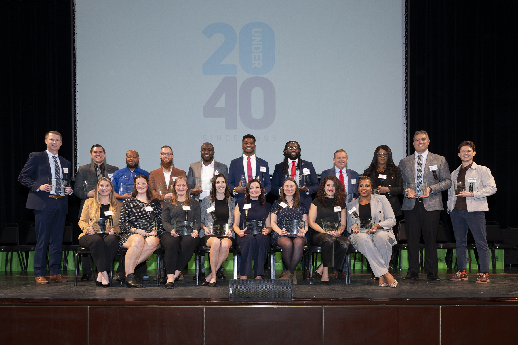 Rob Pasker and 2024 20 Under 40 awardees with blue overlay text